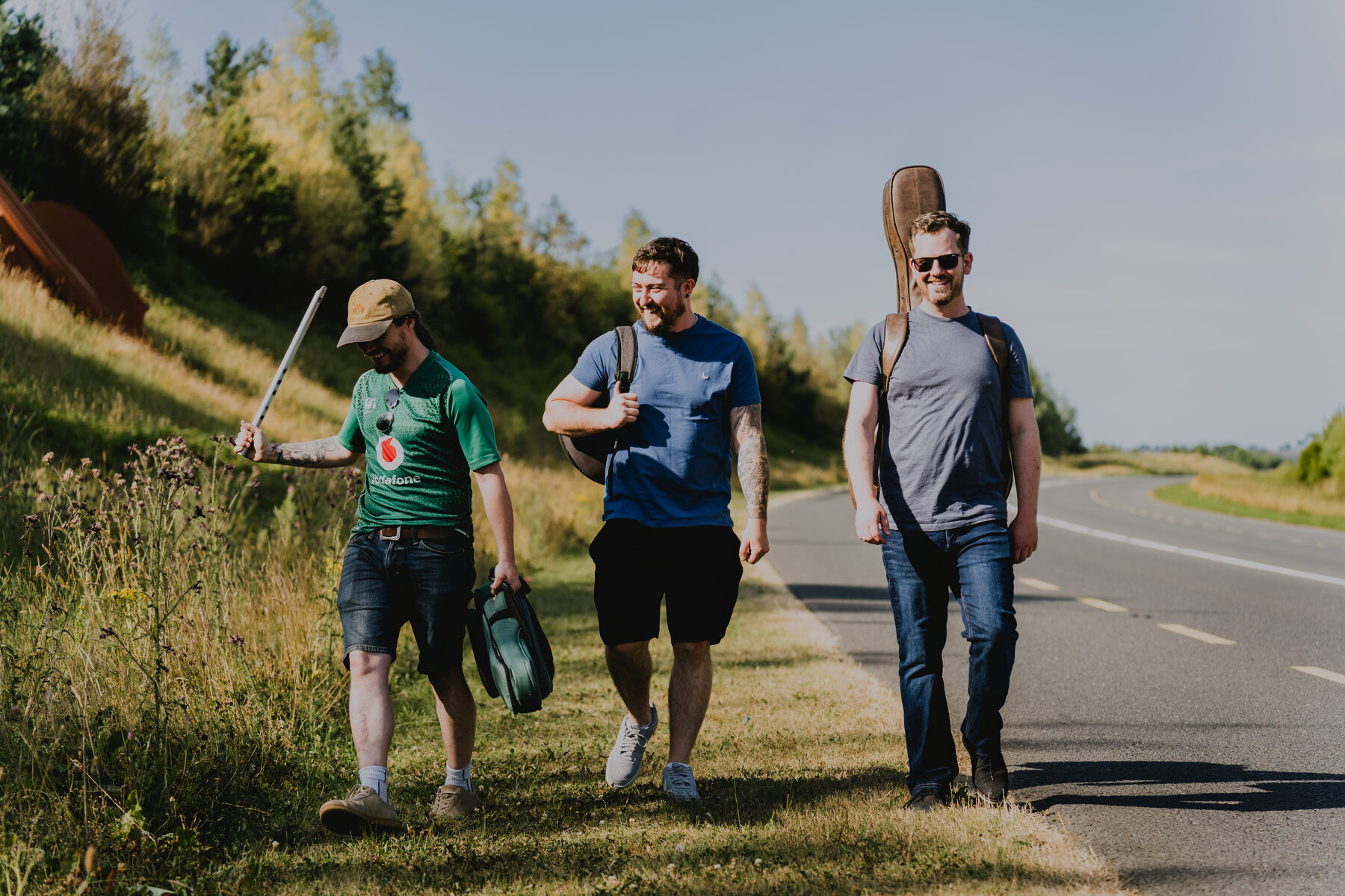 Alan, Conor and Mono walking together with instruments